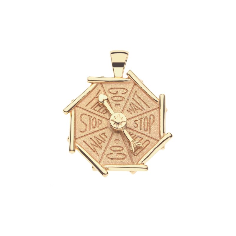 Gold coin pendant with bamboo inspired border and functioning spinner featuring the words "go, yield, stop, and wait"