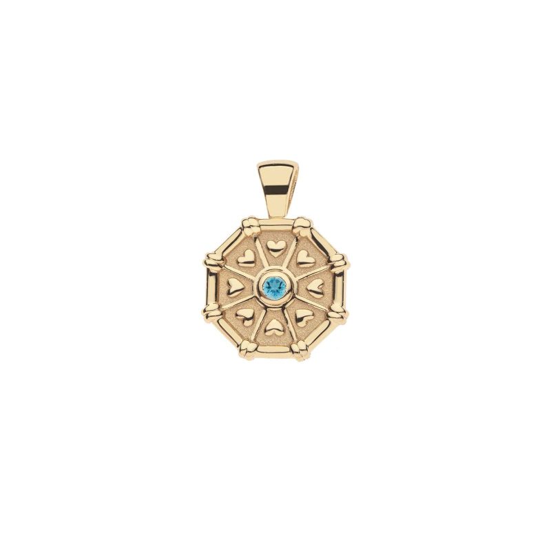 Front of gold birthstone pendant features tiny hearts and a Swiss blue topaz stone for December